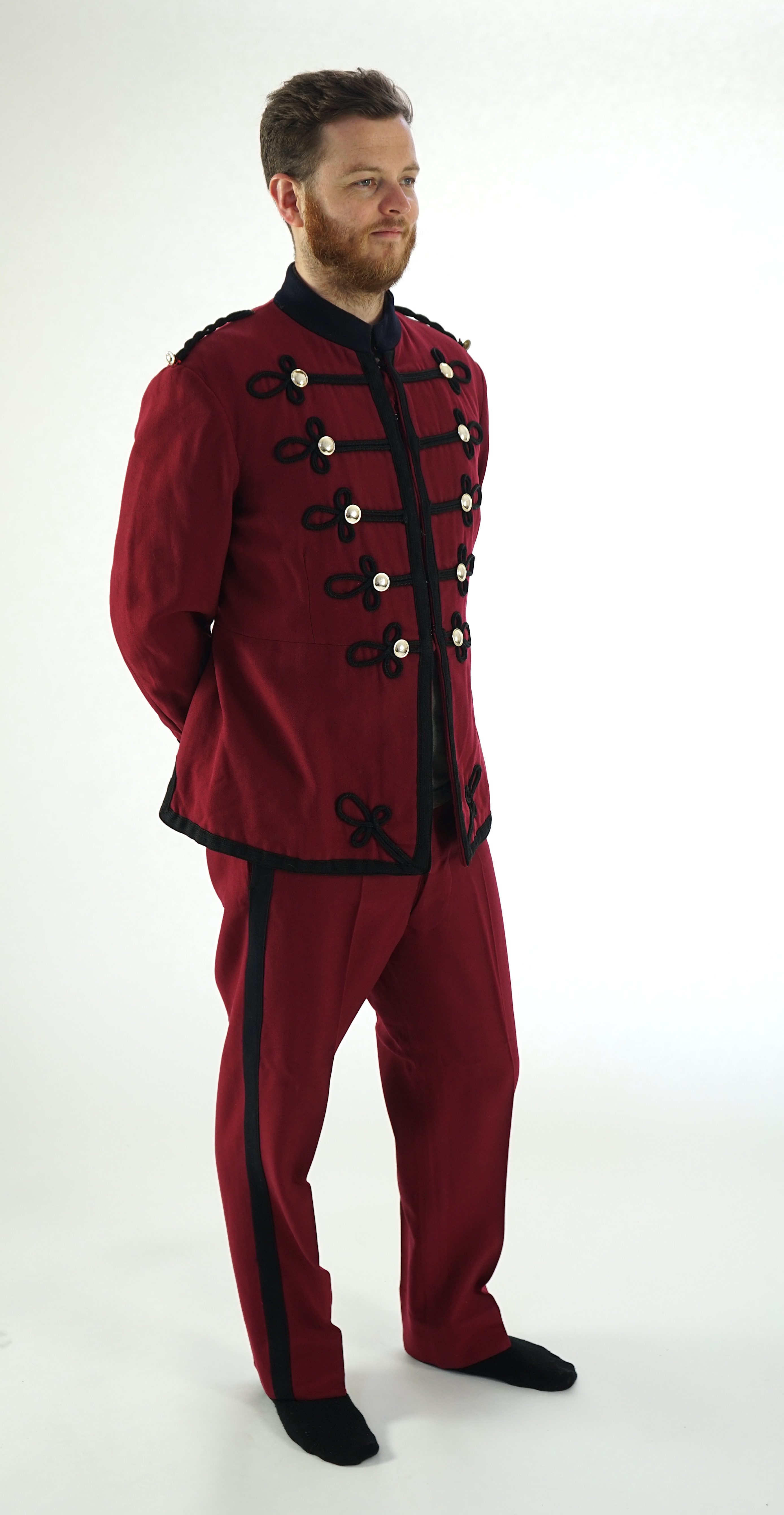 An early 20th century burgundy and black trim Military/Bandsman's uniform jacket and trousers.